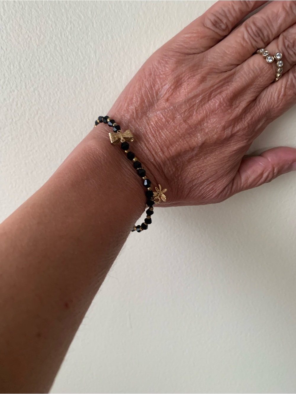 Gold & Black Beaded Bracelet with Butterfly and Clover Charms